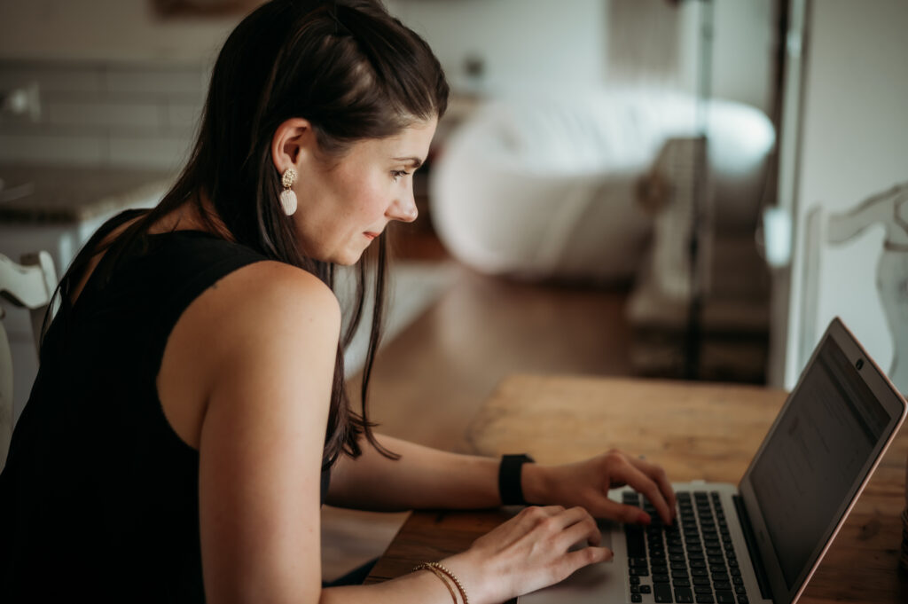 woman working on her laptop at a table