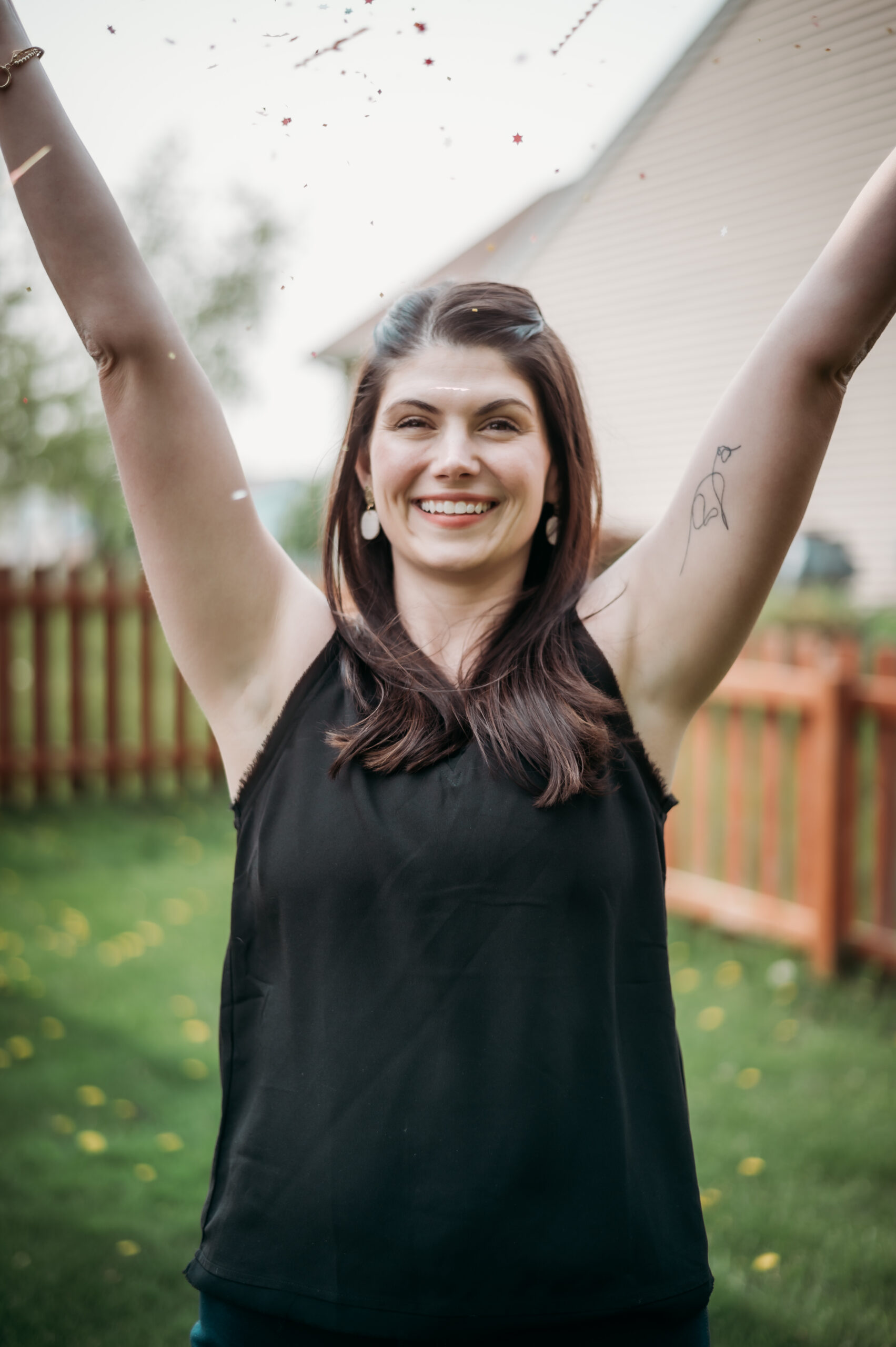 jenna overbaugh with confetti and hands up in the air in celebration