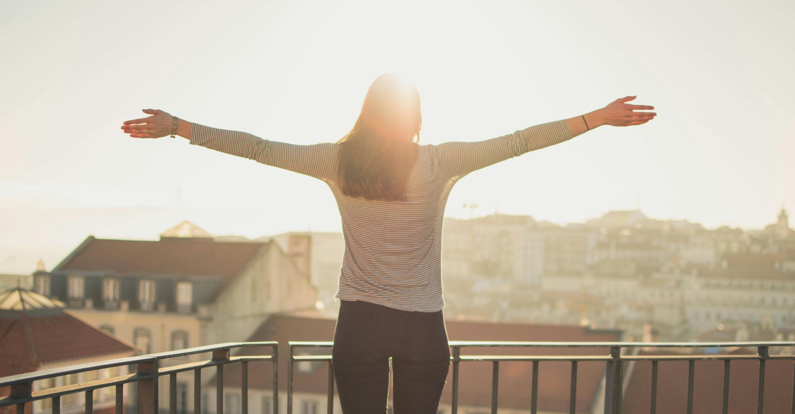 woman outside arms ourstretched and embracing uncertainty