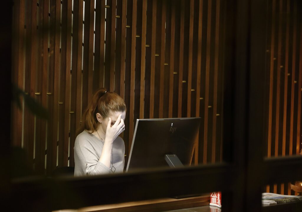 a woman with high-functioning anxiety working on her computer