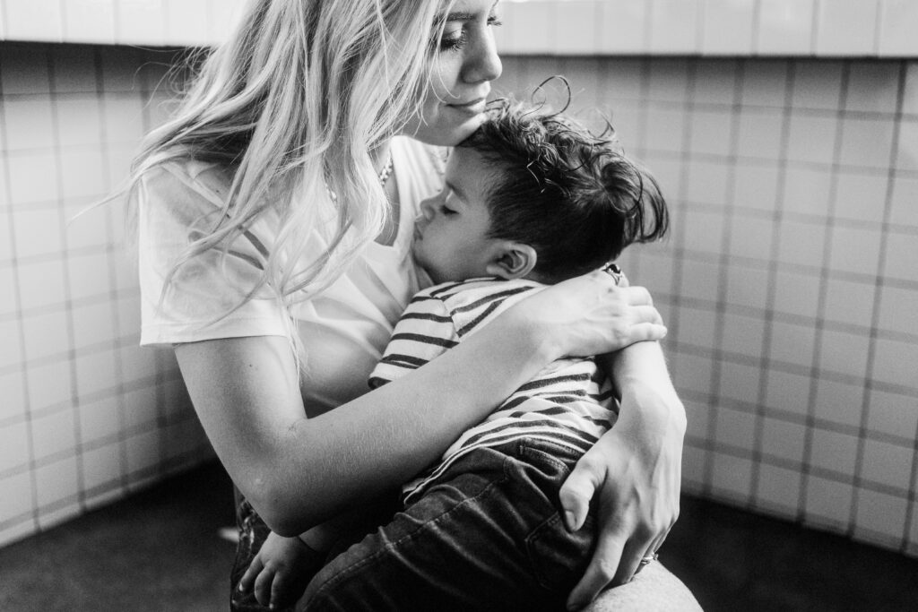 a mother sits holding her child | how to regulate your emotions
