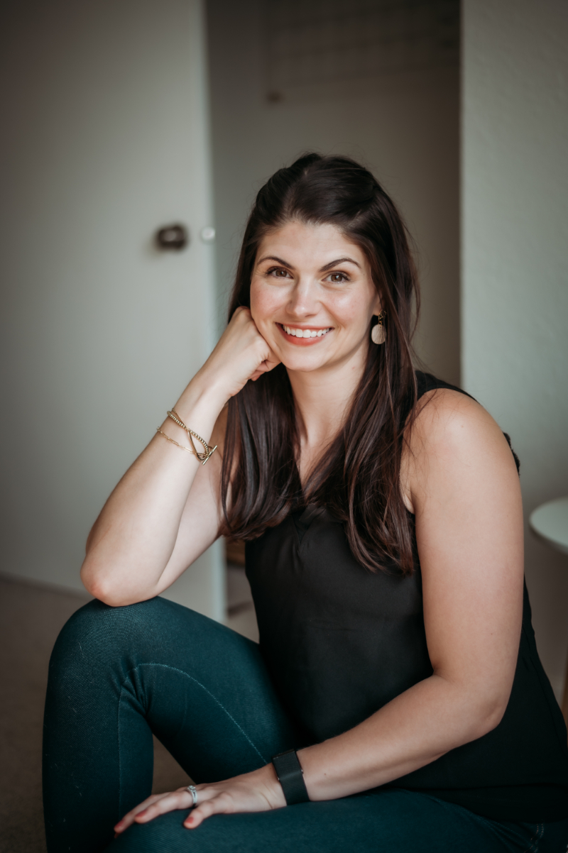 woman sits and smiles at the camera | ocd recovery